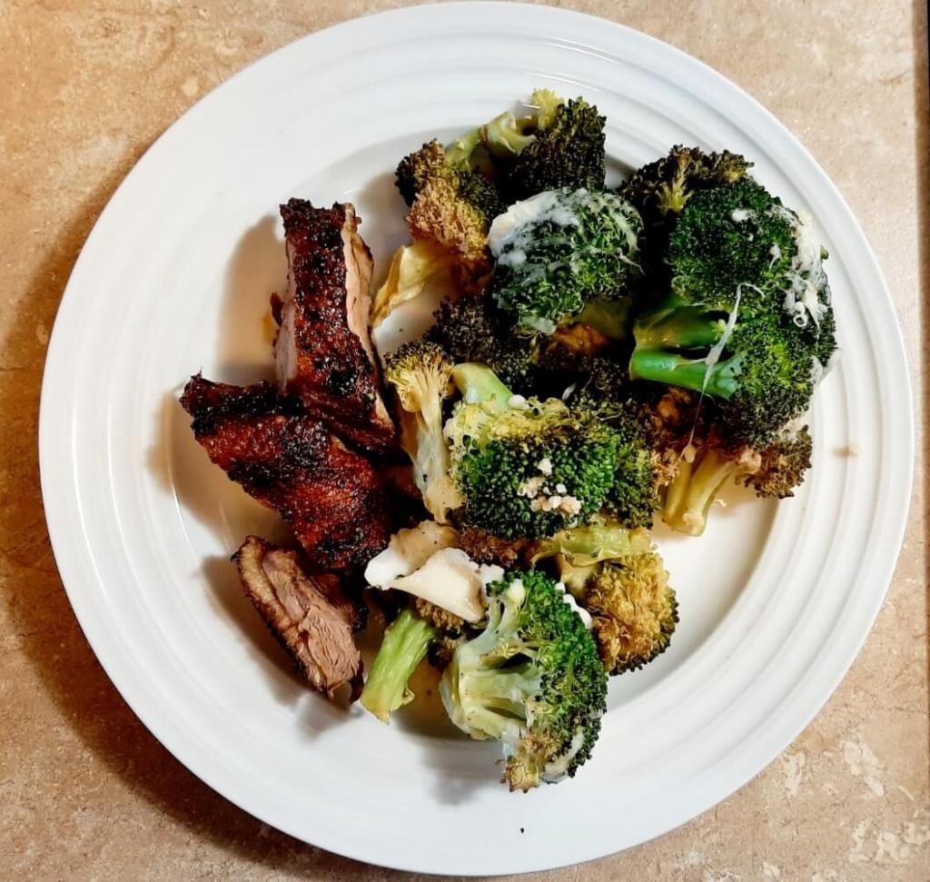 Plate of cut up meat and broccoli