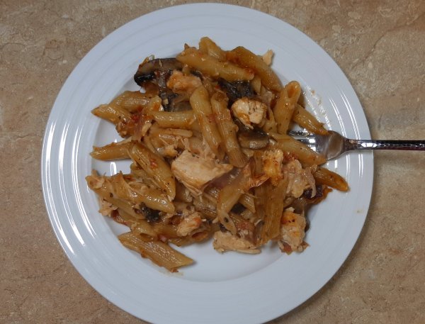 penne pasta, chicken, tomatoes on white plate