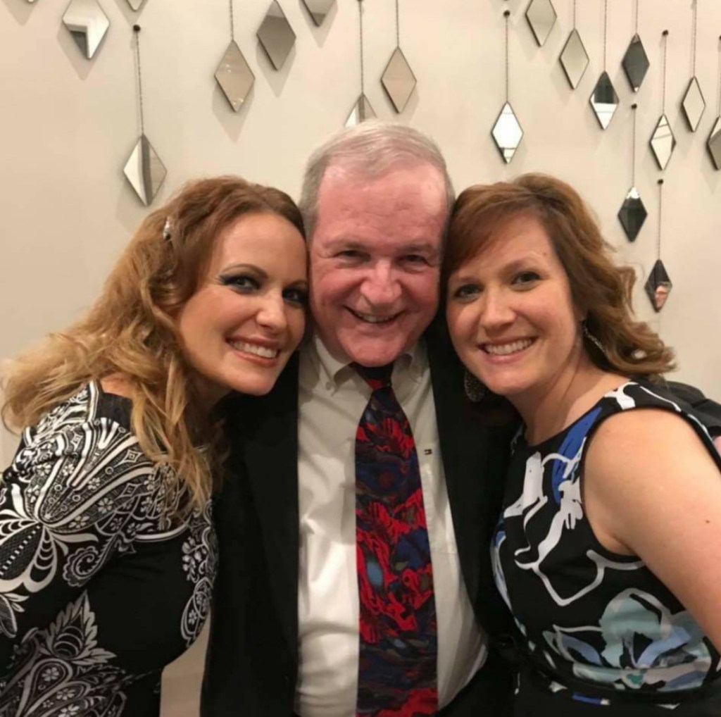 My dad with my youngest sister and me