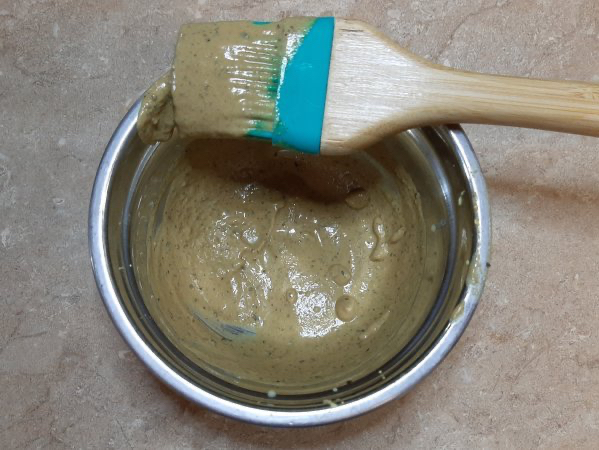 dijon mustard yellow sauce in metal bowl with brush