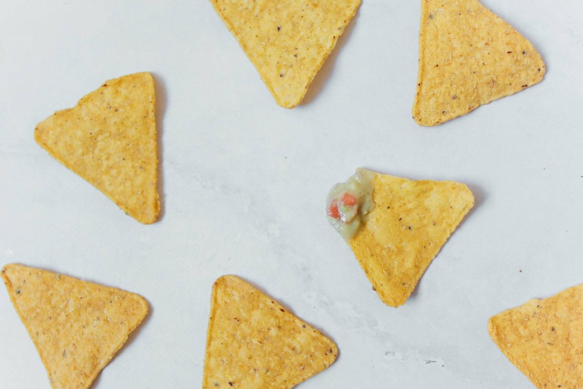 nachos spread out on white background