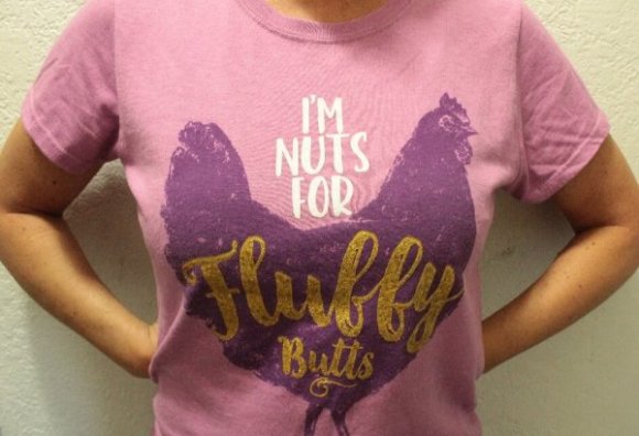person wearing a purple and pink chicken t-shirt