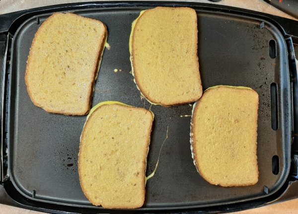 battered toast cooking on griddle