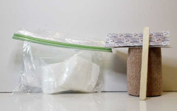 cotton 2x2s, Coban, bandaids, and popsicle stick