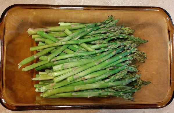fresh asparagus in a glass loaf pan