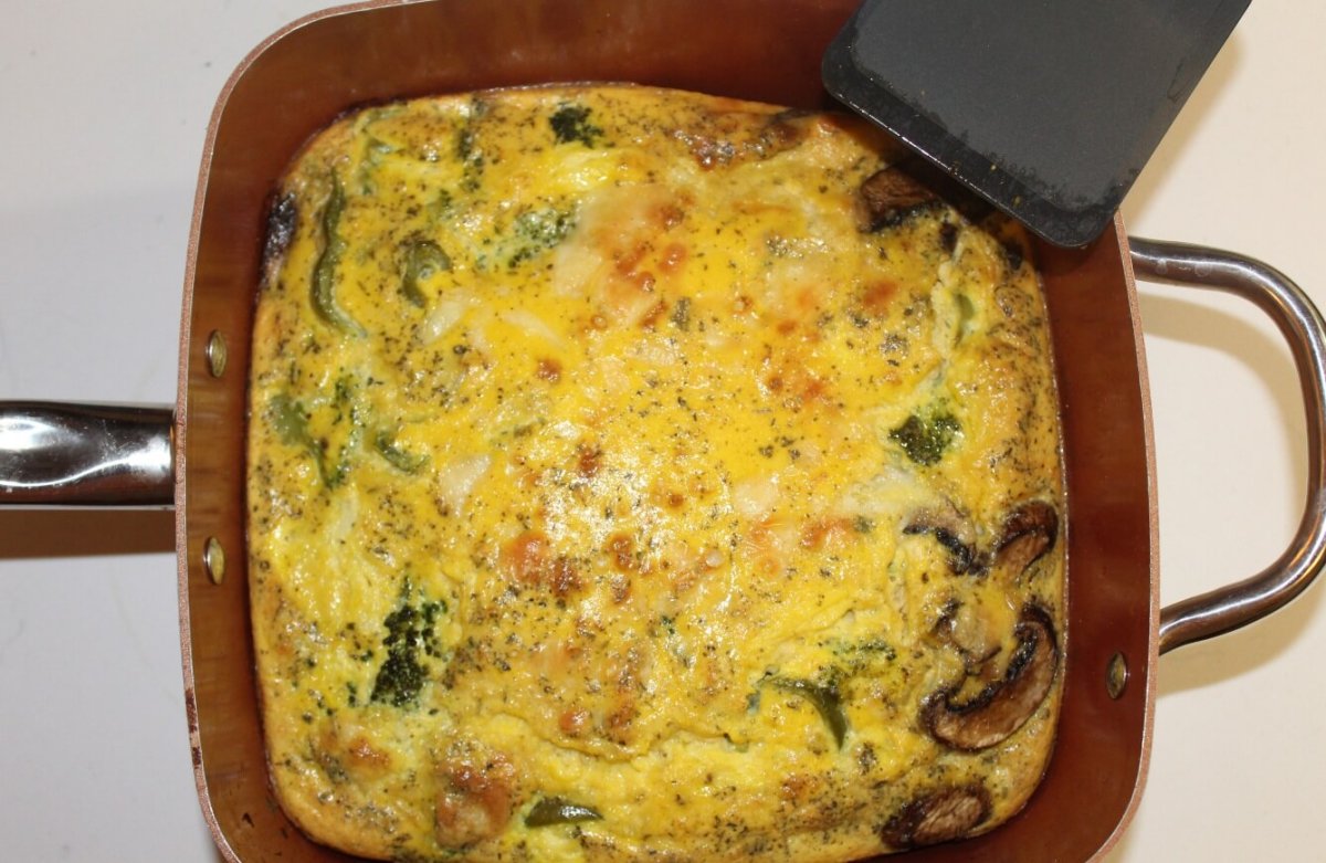 egg meal with vegetables in a square copper pan