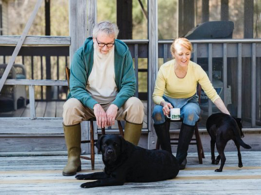 elderly couple looking at their dogs
