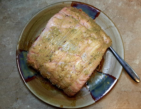 top of prime rib roast on plate with mustard sauce on it