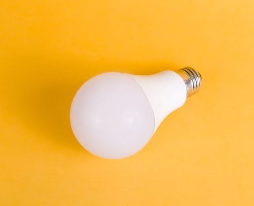 white LED bulb on yellow background