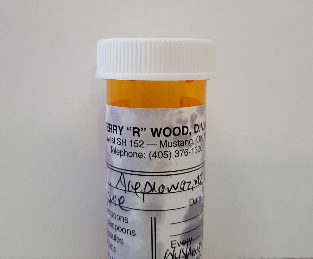 prescription bottle with illegible writing on it